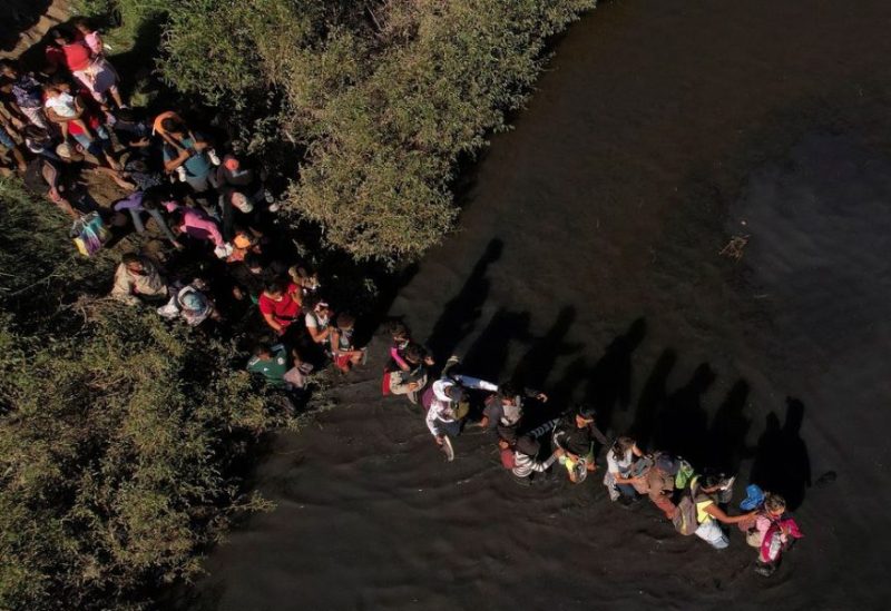 Migrants, who were stranded a day earlier near Villa Ahumada, and who are seeking asylum in the United States, cross the Rio Bravo river, as seen from Ciudad Juarez , Mexico September 30, 2023