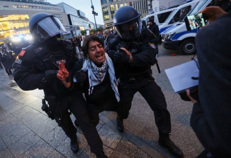 Police officers take away a person during a pro-Palestinian demonstration as the conflict between Israel and Hamas continues, in Frankfurt, Germany, October 18, 2023.