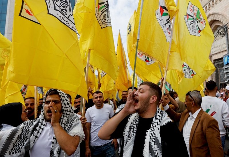 People hold Fatah flags during a protest in support of the people of Gaza, as the conflict between Israel and Palestinian Islamist group Hamas continues, in Hebron, in the Israeli-occupied West Bank, October 27, 2023. REUTERS/Mussa Qawasma