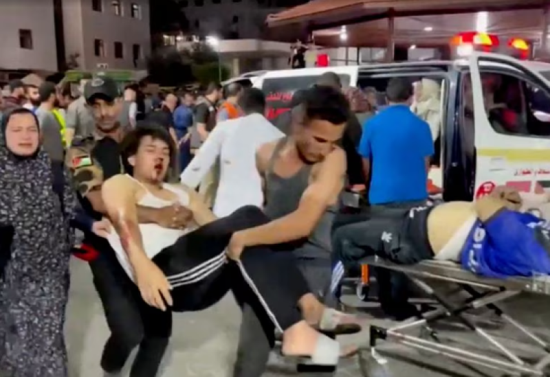 An injured person is taken into a hospital after Israeli air strike hit a hospital, according to Hamas Health Ministry in Gaza City, Gaza Strip, in this screen grab obtained from video October 17, 2023.