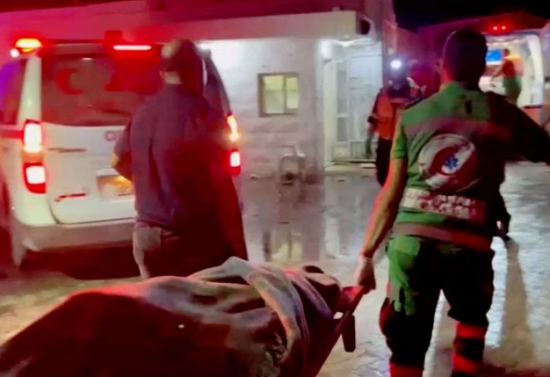 Rescue personnel work at scene At Al-Ahli Hospital, after hundreds of Palestinians were killed in a blast at Al-Ahli hospital in Gaza that Israeli and Palestinian officials blamed on each other in Gaza City, Gaza Strip, in this screen grab obtained from video, October 17, 2023.