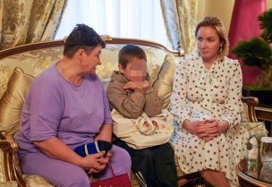 A 7-year-old Ukrainian boy, who is the first child released under a new mechanism Qatar has set up with the goal of repatriating children from Russia to Ukraine, is seated next to his grandmother (L) and Russia's Commissioner for Children's Rights, Maria Lvova-Belova after being released to Qatari diplomats in this handout image taken at Qatar's embassy in Moscow, Russia October 13, 2023. Qatar's Ministry of Foreign Affairs/Handout via REUTERS THIS IMAGE HAS BEEN SUPPLIED BY A THIRD PARTY. MANDATORY CREDIT. NO RESALES. NO ARCHIVES. IMAGE HAS BEEN BLURRED AT SOURCE.