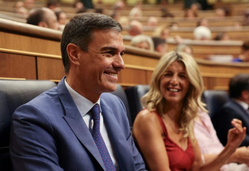Spain's left-wing Sumar leader Yolanda Diaz and Spain's acting Prime Minister and Socialist Party (PSOE) leader Pedro Sanchez sit on the day of a parliament session where lawmakers vote for a speaker and for members of the parliament's executive board