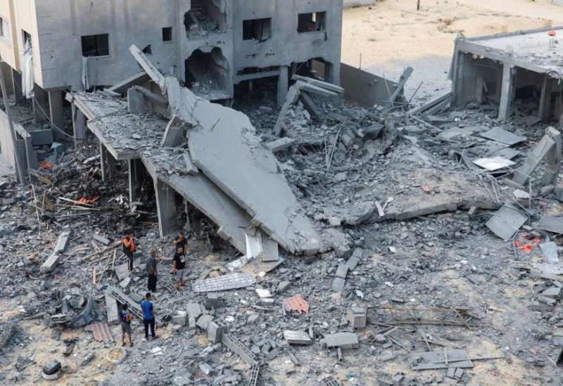 Palestinians inspect the site of Israeli strikes on a house in Khan Younis in the southern Gaza Strip, October 23, 2023.