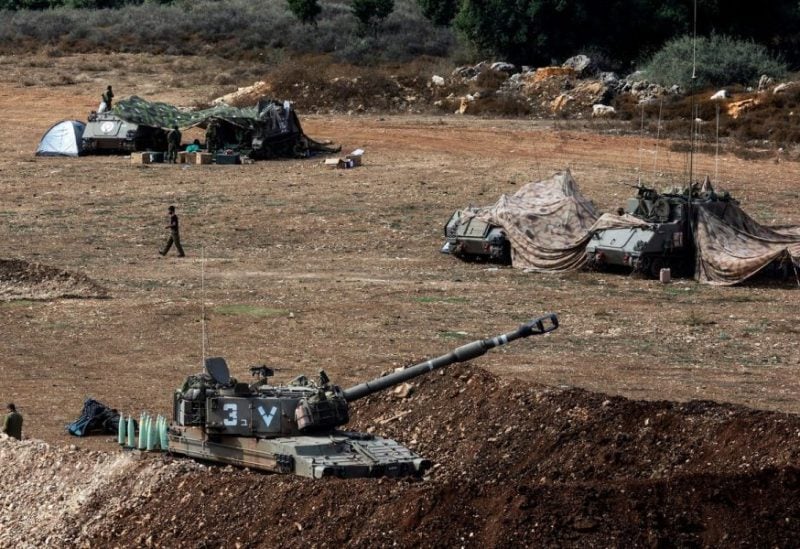 A view shows an Israeli tank and military vehicles near Israel's border with Lebanon, northern Israel, October 9, 2023. REUTERS
