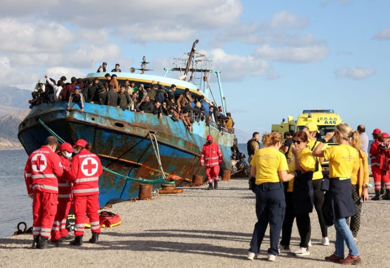 Red Cross volunteers and rescue crews stand next to a fishing boat carrying migrants at the port of Paleochora, following a rescue operation off the island of Crete, Greece, November 22, 2022. REUTERS/Stringer/File Photo