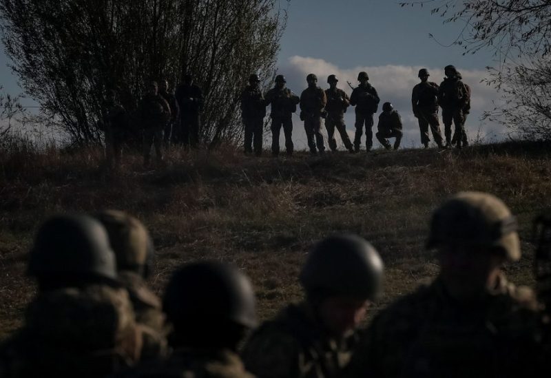 Ukrainian servicemen stand as a ferry carries their counterparts during an exercise, amid Russia's attack on Ukraine, in Chernihiv region, Ukraine November 2, 2023. REUTERS/Gleb Garanich