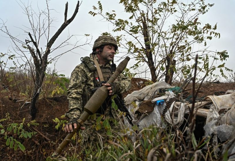 A Ukrainian serviceman inspects a RPG-7 shell at a former Russian position outside the village of Robotyne, amid Russia's attack on Ukraine, near a front line in Zaporizhzhia region, Ukraine November 4, 2023. REUTERS/Stringer