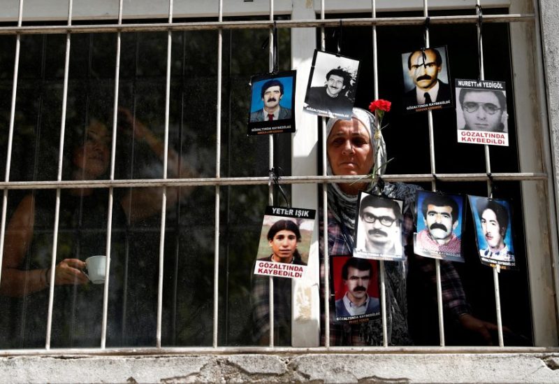A member of the Saturday Mothers looks out of the window of Human Rights Association after they were prevented by the security forces to march to Galatasaray Square, where they hold a vigil every week, sitting in silence and holding pictures of relatives who went missing in police detention, in Istanbul, Turkey September 8, 2018. REUTERS/Murad Sezer