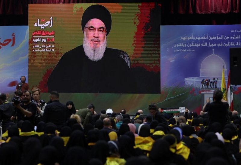 Lebanon's Hezbollah leader Sayyed Hassan Nasrallah addresses his supporters through a screen during a rally commemorating the annual Hezbollah Martyrs' Day, in Beirut's southern suburbs, Lebanon November 11, 2023. REUTERS/Aziz Taher