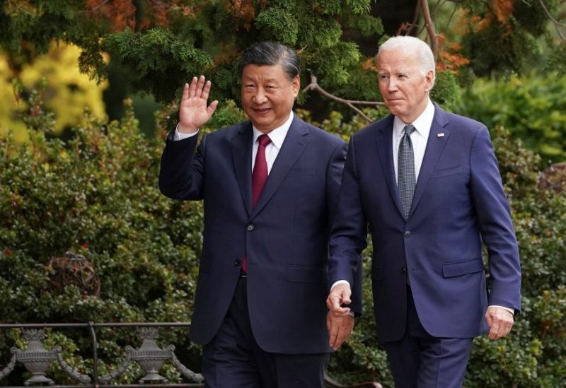 Chinese President Xi Jinping waves as he walks with U.S. President Joe Biden at Filoli estate on the sidelines of the Asia-Pacific Economic Cooperation (APEC) summit, in Woodside, California, U.S., November 15, 2023. REUTERS/Kevin Lamarque