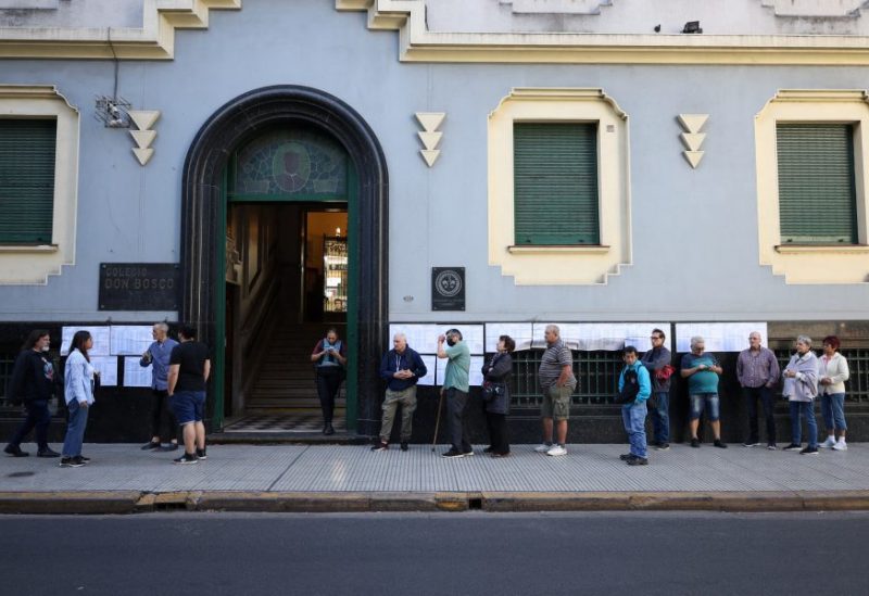 People stand outside a polling station during Argentina's runoff presidential election, in Buenos Aires, Argentina November 19, 2023. REUTERS/Cristina Sille