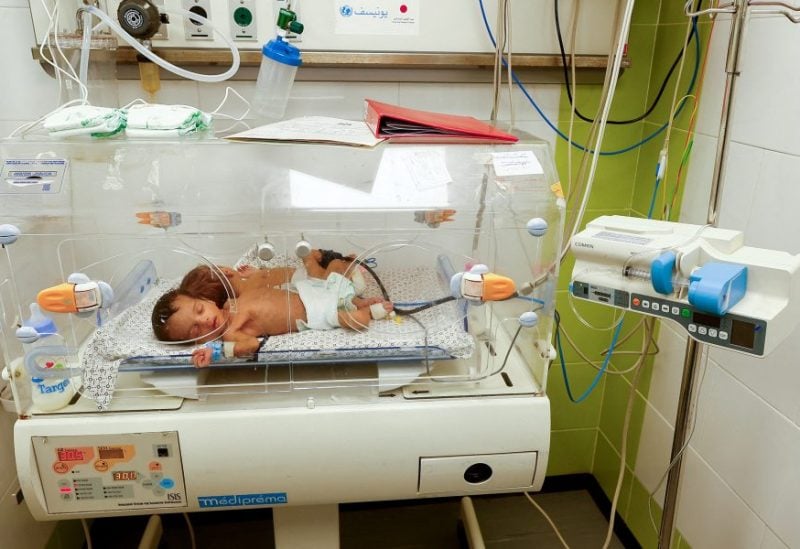 A premature baby who was evacuated from north Gaza's Al Shifa Hospital due to Israeli military operations lies in an incubator at a hospital in Rafah, southern Gaza Strip, November 21, 2023. REUTERS/Ibraheem Abu Mustafa/File Photo
