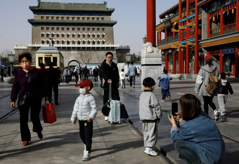 People walk at a tourism site in Qianmen street, Beijing, China March 14, 2023. REUTERS/Tingshu Wang/File Photo