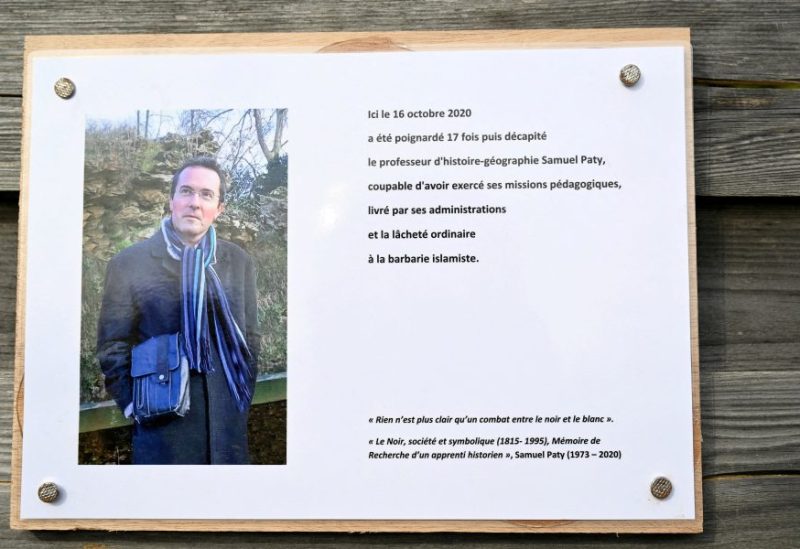 A photograph taken on October 16, 2023 shows a commemorative plaque for slain teacher Samuel Paty (portrait) near the Bois d'Aulne school in Conflans-Sainte-Honorine, outside Paris. BERTRAND GUAY/Pool via REUTERS/File Photo