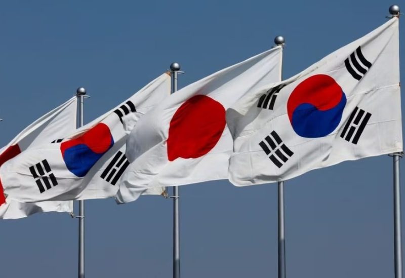 A view of South Korean and Japanese national flags hoisted ahead of the arrival of South Korea's President Yoon Suk Yeol and his wife Kim Keon-hee, at Tokyo International Airport (Haneda Airport) in Tokyo, Japan March 16, 2023. REUTERS/Issei Kato/File Photo