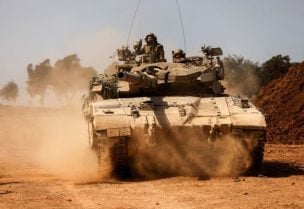 An Israeli tank takes position near Israel's border with the Gaza Strip, in southern Israel, October 13, 2023. REUTERS/Amir Cohen