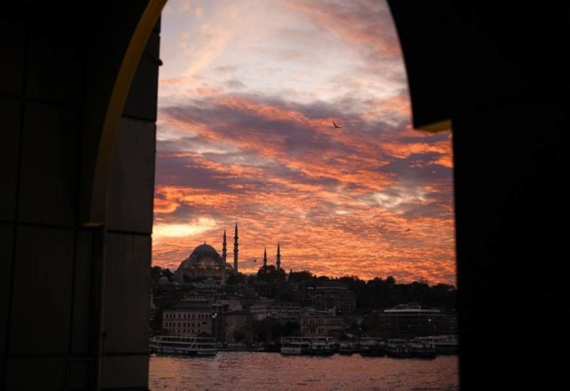 Seagulls fly over the Bosphorus as the sun sets behind Suleymaniye mosque in Istanbul, Türkiye, Friday, Nov. 17, 2023