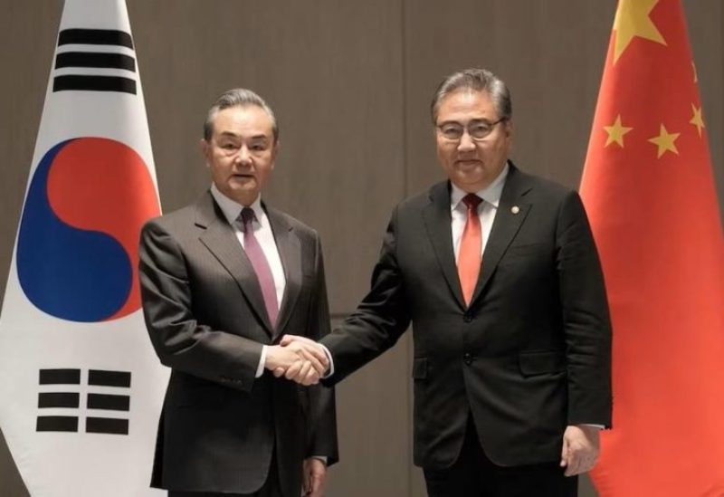 South Korean Foreign Minister Park Jin, right, shakes hands with his Chinese counterpart Wang Yi prior to a meeting in Busan, South Korea, Sunday, Nov. 26, 2023.
