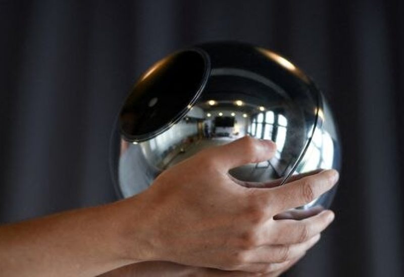 Hands hold the biometric imaging device, the Orb, of the identity and financial public utility Worldcoin, which aims to create a World ID digital passport, with a tradeable cryptocurrency, in Berlin, Germany August 1, 2023. REUTERS/Annegret Hilse