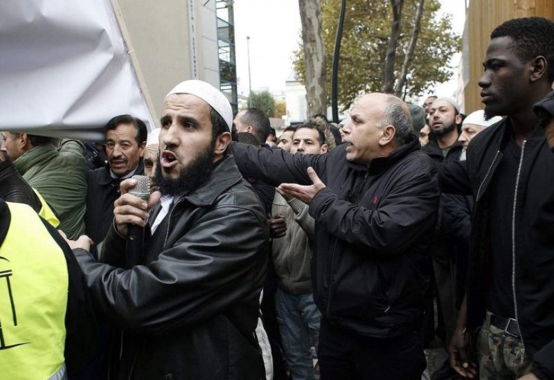 Muslims protest against the closure of a prayer room in the Paris suburb of Clichy la Garenne, Friday, Nov. 10, 2017. Tensions have erupted as residents and the mayor of a Paris suburb tried to block the town’s Muslims from praying in the street in a dispute that reflects nationwide problems over mosque shortages. (AP Photo/Thibault Camus)