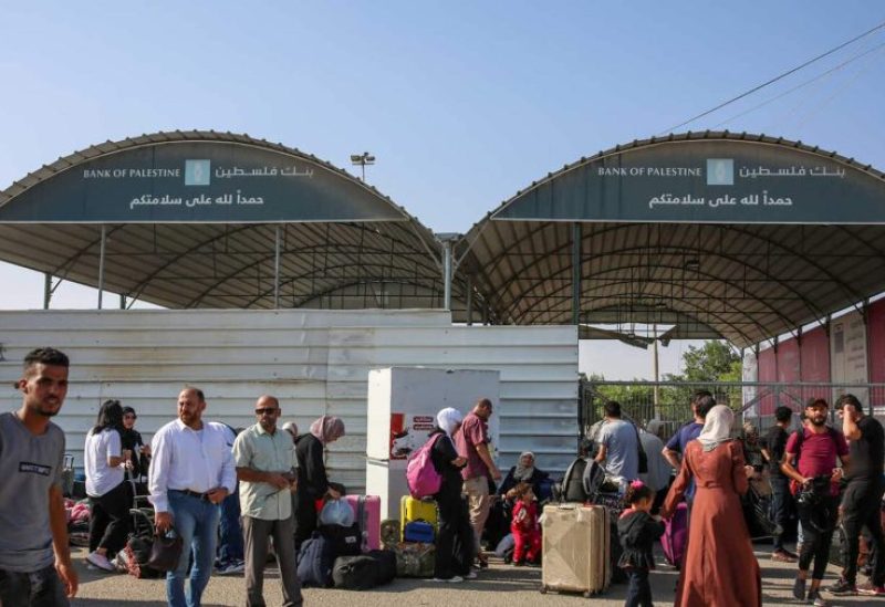 People wait at the Rafah border crossing with Egypt in the southern Gaza Strip on November 1, 2023. [Mohammed Abed/AFP]