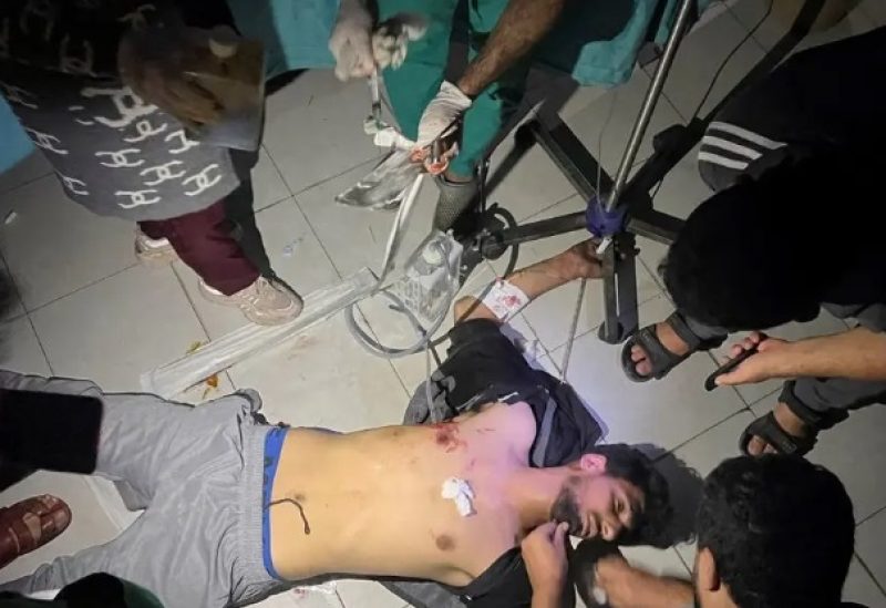 Medical services use phone flashlights to assist a Palestinian wounded in Israeli strikes at the Indonesian hospital after Al-Shifa hospital has gone out of service amid Israeli ground offensive, in the northern Gaza Strip, November 16, 2023.