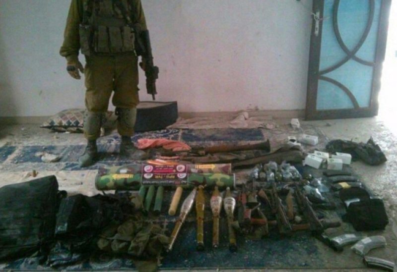 Weapons and equipment which the Israeli military says it found at a house in a location given as Gaza, are seen in this handout image released November 21, 2023. Israel Defense Forces/Handout via REUTERS THIS IMAGE HAS BEEN SUPPLIED BY A THIRD PARTY. REUTERS WAS NOT ABLE TO CONFIRM THE LOCATION OR THE DATE THE VIDEO WAS FILMED.