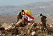 Hezbollah fighters fly movement's standard next to Lebanon's flag in Jouroud Arsal