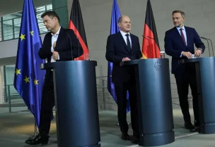 German Economy and Climate Minister Robert Habeck, Chancellor Olaf Scholz and Finance Minister Christian Lindner leave following their comments on the ruling of Germany's Constitutional court