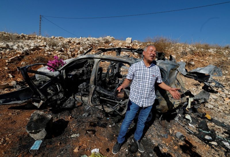 Samir Ayoub, uncle of three Lebanese girls killed along with their grandmother yesterday, by what he says was an Israeli airstrike that targeted their car in which they were traveling between Aytaroun and Aynata, speaks as he mourns them beside the burned car near the Lebanon and Israel border, in the outskirts of the southern town of Aynata, Lebanon November 6, 2023. REUTERS/Zohra Bensemra TPX IMAGES OF THE DAY