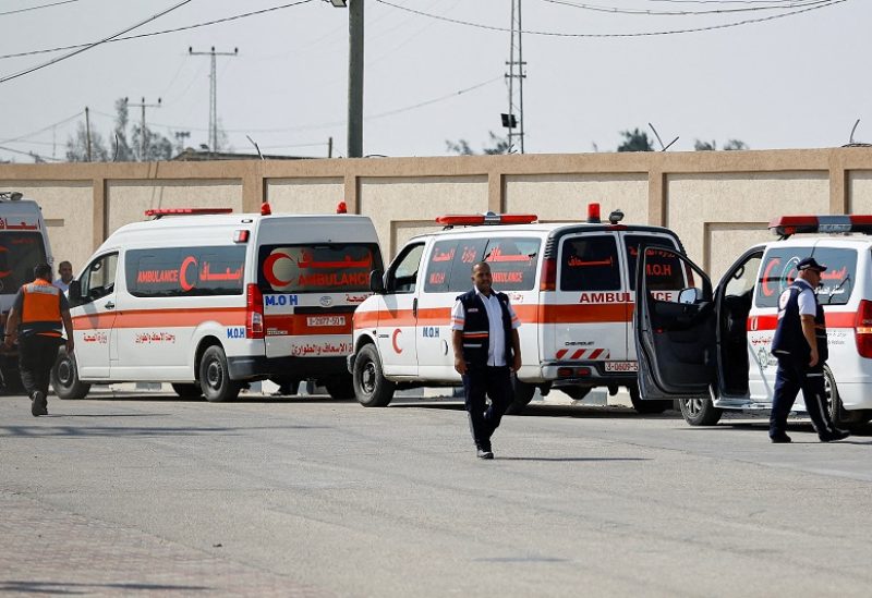 FILE PHOTO: Medical workers wait to take injured Palestinians who will receive treatment in Egyptian hospitals, at the Rafah border crossing with Egypt, in the southern Gaza Strip, November 1, 2023. REUTERS/Ibraheem Abu Mustafa/File Photo