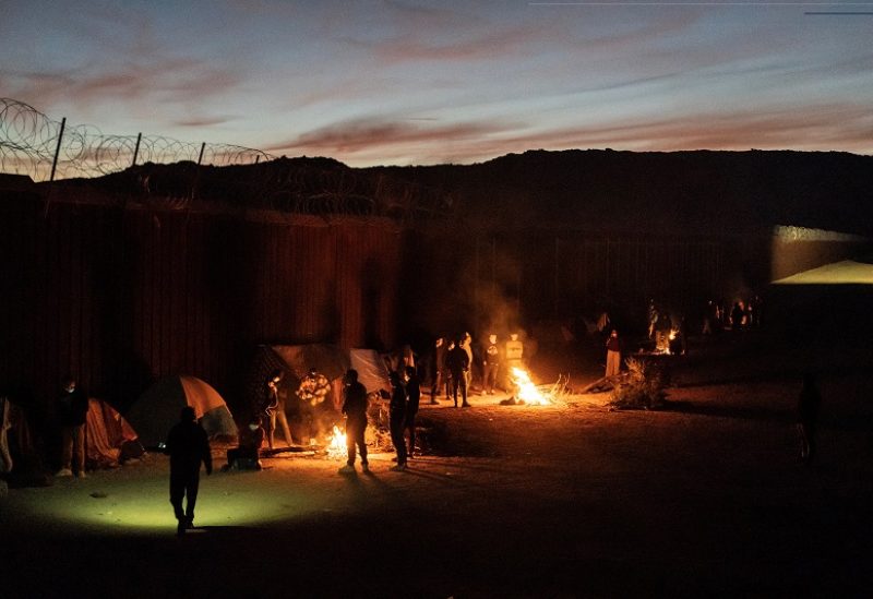 Migrants mostly from China and Colombia burn wood to keep warm as they wait to be transported by U.S. Border Patrol agents after crossing the border into the U.S. from Mexico in Jacumba Hot Springs, California, U.S., November 10, 2023. REUTERS/Go Nakamura