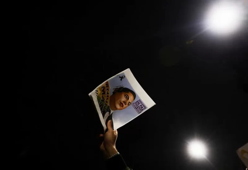 A person holds a poster of Ociel Baena during a protest in memory of them, Mexico's first openly non-binary magistrate who was found dead at home, Mexico City, Mexico, November 13, 2023