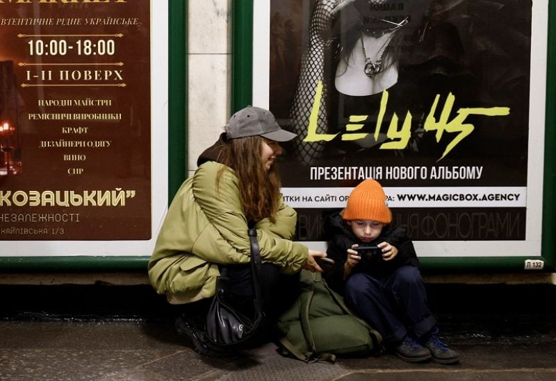 People sit in a metro station to shelter from an air raid, during Russia's attack on Ukraine, in Kyiv, Ukraine, November 11, 2023. REUTERS/Thomas Peter