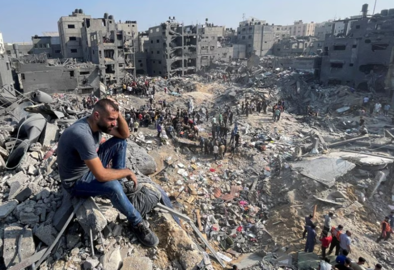 A man gestures as Palestinians search for casualties a day after Israeli strikes on houses in Jabalia refugee camp in the northern Gaza Strip, November 1, 2023.