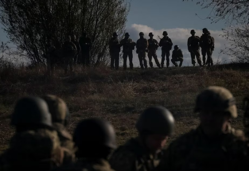 Ukrainian servicemen stand as a ferry carries their counterparts during an exercise, amid Russia's attack on Ukraine, in Chernihiv region, Ukraine November 2, 2023.