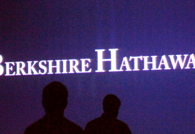 Berkshire Hathaway shareholders walk by a video screen at the company's annual meeting in Omaha May 4, 2013