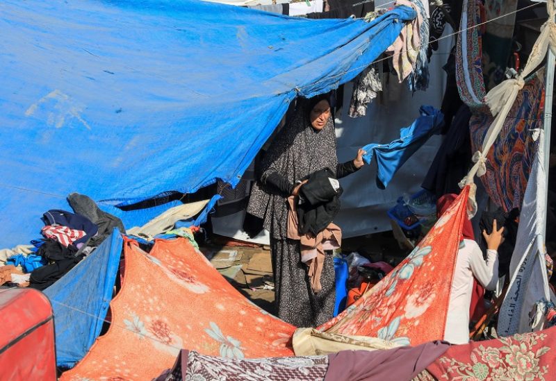 A displaced Palestinian woman, who fled her house due to Israeli strikes, collects laundry in a makeshift shelter at Shifa hospital, amid the ongoing conflict between Israel and Palestinian Islamist group Hamas, in Gaza City November 5, 2023. REUTERS/Mohammed Al-Masri