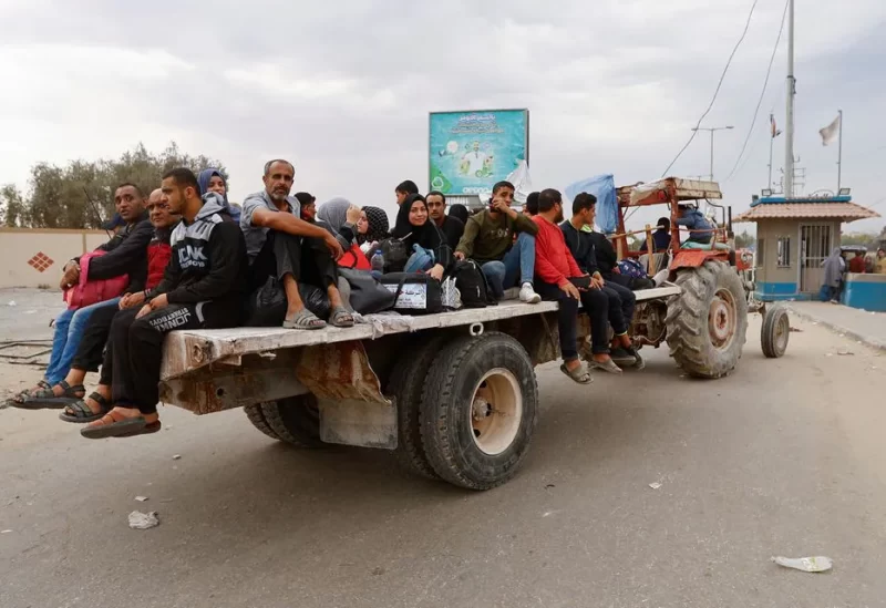Palestinians fleeing north Gaza ride in the back of a truck as they move southward, as Israeli tanks roll deeper into the enclave, amid the ongoing conflict between Israel and Hamas, in the central Gaza Strip November 12, 2023