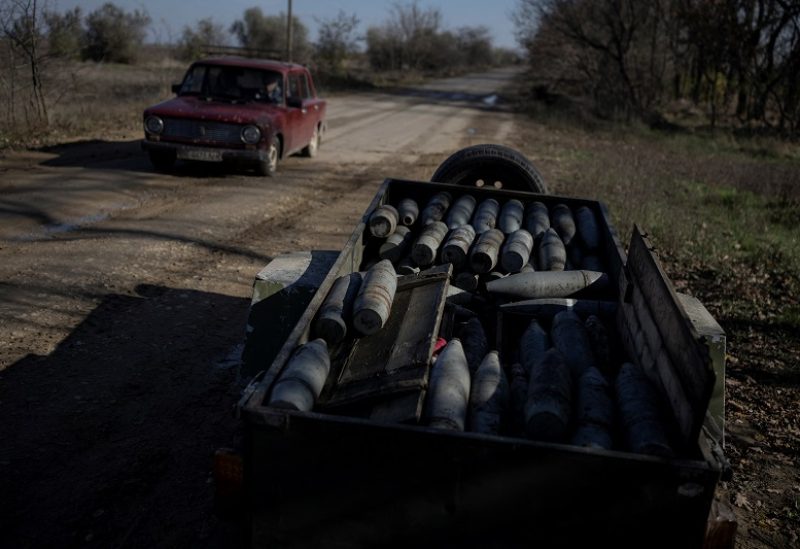 A local resident drives a car past artillery shells found by Ukrainian sappers, amid Russia's attack on Ukraine, in Kherson region, Ukraine November 9, 2023. REUTERS/Viacheslav Ratynskyi