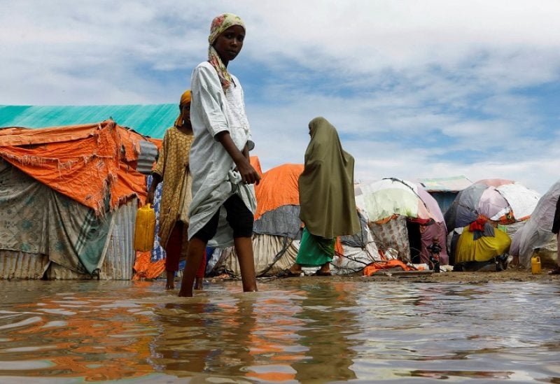 Residents wade through flood waters within their makeshift shelters at the Al-Hidaya camp for the internally displaced people following heavy rains in the outskirts of Mogadishu, Somalia November 19, 2023 REUTERS/Feisal Omar