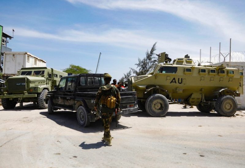 African Union peacekeepers stand next to armoured personnel carriers (APC) as they provide security for members of the Lower House of Parliament who are meeting to elect a speaker, at the Aden Adde International Airport in Mogadishu, Somalia, April 27, 2022. REUTERS/Feisal Omar/File Photo