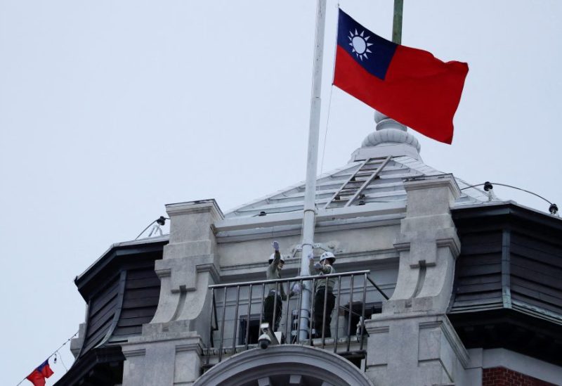 Honor guards raise a Taiwanese flag at the Presidential Palace ahead of the National Day celebration ceremony in Taipei, Taiwan October 10, 2023. REUTERS/Carlos Garcia Rawlins/File Photo