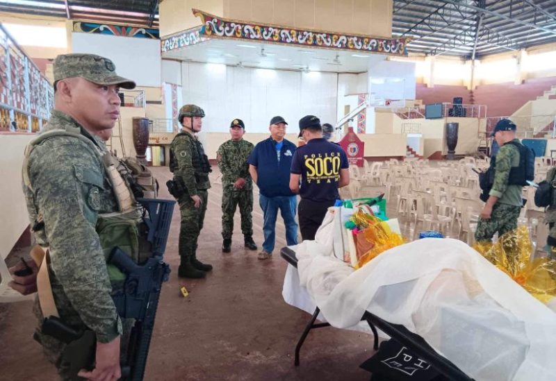 Lanao Del Sur Governor Mamintal Adiong Jr. stands among law enforcement officers as they investigate the scene of an explosion that occurred during a Catholic Mass in a gymnasium at Mindanao State University in Marawi, Philippines, December 3, 2023. Lanao Del Sur Provincial Government/Handout via REUTERS