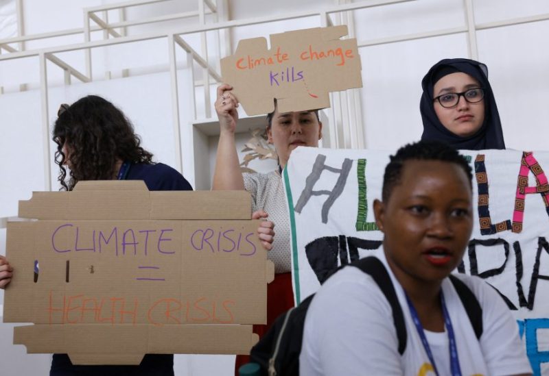 Members of the International Federation of Medical Students Associations hold placards during a protest demanding an end to fossil fuels at COP28 World Climate Summit, in Dubai, United Arab Emirates, December 3, 2023. REUTERS/Amr Alfiky