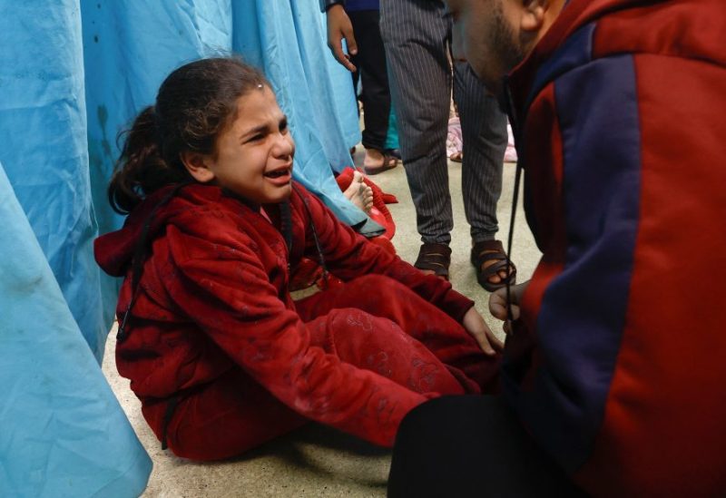 A wounded Palestinian child sits on the floor of Nasser hospital following Israeli strikes, amid the ongoing conflict between Israel and Palestinian Islamist group Hamas, in Khan Younis in the southern Gaza Strip, December 8, 2023. REUTERS/Ibraheem Abu Mustafa