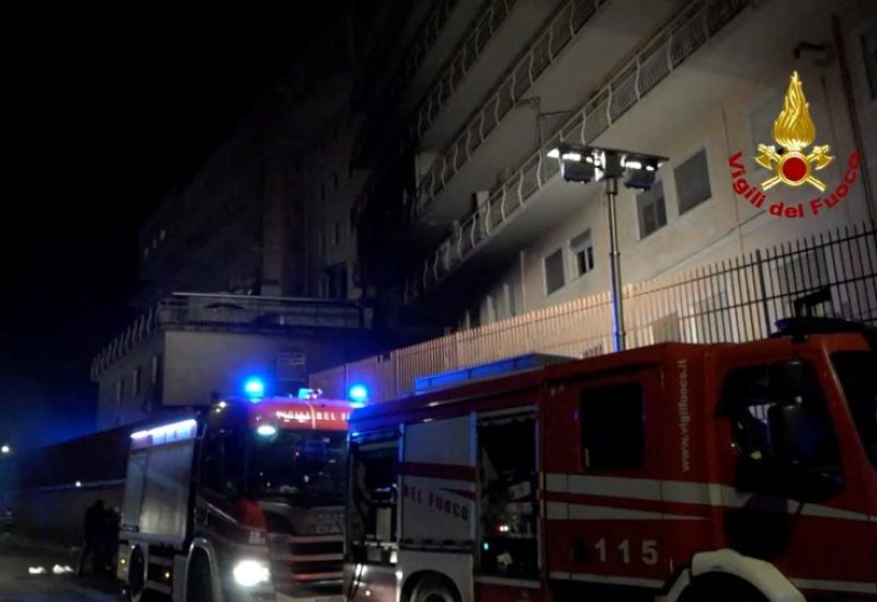 People walk next to fire engines parked at the San Giovanni Evangelista hospital, following a deadly fire, in Tivoli, around 30 km from Rome, Italy December 9, 2023. Vigili del fuoco/Handout via REUTERS