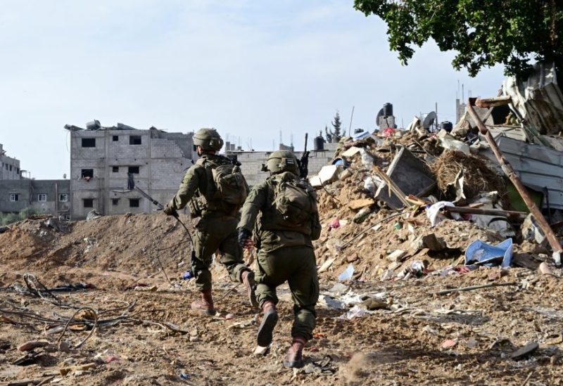Israeli soldiers operate at the Shajaiya district of Gaza city amid the ongoing conflict between Israel and the Palestinian Islamist group Hamas, in the Gaza Strip December 8, 2023. REUTERS/Yossi Zeliger ISRAEL OUT. NO COMMERCIAL OR EDITORIAL SALES IN ISRAEL