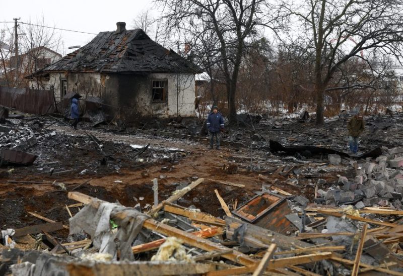 Local residents stand at a site of residential buildings, heavily damaged by a Russian missile strike, amid Russia's attack on Ukraine, in Kyiv, Ukraine December 11, 2023. REUTERS/Valentyn Ogirenko